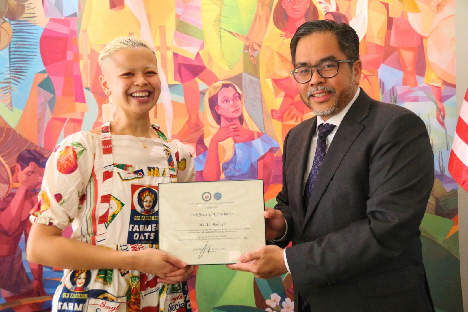 Deputy Chief of Mission Jaime Ramon T. Ascalon, Jr. (right) hands over a Certificate of Appreciation to Ms. Abi Balingit (left).