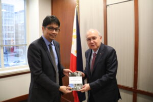 Professor Erwin Tiongson (left) presents a copy of his book to Ambassador Jose Manuel Romualdez (right)