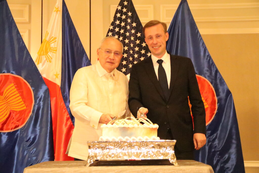 Ambassador Romualdez (left) and NSA Sullivan (right) cut the cake in celebration of the 125th anniversary of Philippine Independence and Nationhood.