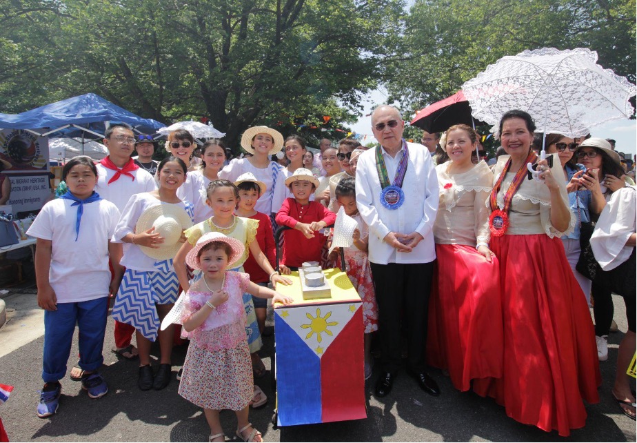 10 June 2023 - Ambassador Jose Manuel G. Romualdez poses with some of the children at the Filipino street festival.