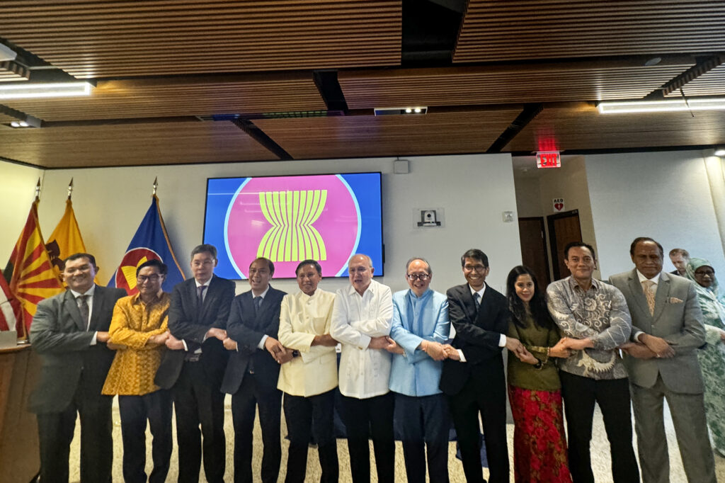 ASEAN Ambassadors and Deputy Chiefs of Missions are joined by Timor-Leste Ambassador for the signature ASEAN handshake during celebrations for the 57 th founding anniversary of the regional grouping