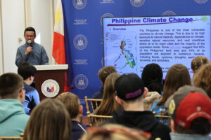 Consul Jahzeel Abihail G. Cruz presents an engaging briefing on the impacts of climate change in the Philippines and the country's efforts to mitigate them during the Southwest Middle School students’ visit.