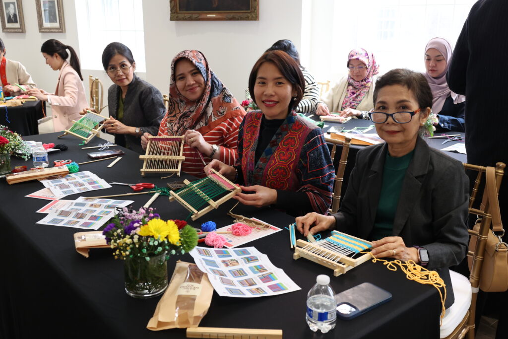 Spouses of the ASEAN Ambassadors in Washington, D.C., and other ASC members share a moment of creativity and camaraderie as they explore the relaxing and timeless art of weaving with their mini looms.