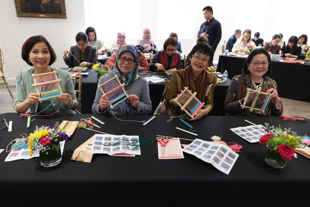 Spouses of the ASEAN Ambassadors in Washington, D.C., and other ASC members share a moment of creativity and camaraderie as they explore the relaxing and timeless art of weaving with their mini looms.