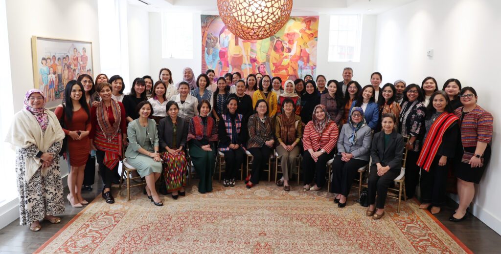 Members of the ASEAN Spouses Circle close the Weave Your Way: Mini Loom Weaving Workshop with a family photo.