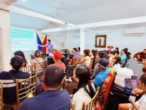 Labor Attaché Saul De Vries conducts an orientation on the programs and services of the Department of Migrant Workers for the OFW-participants in Tobago.