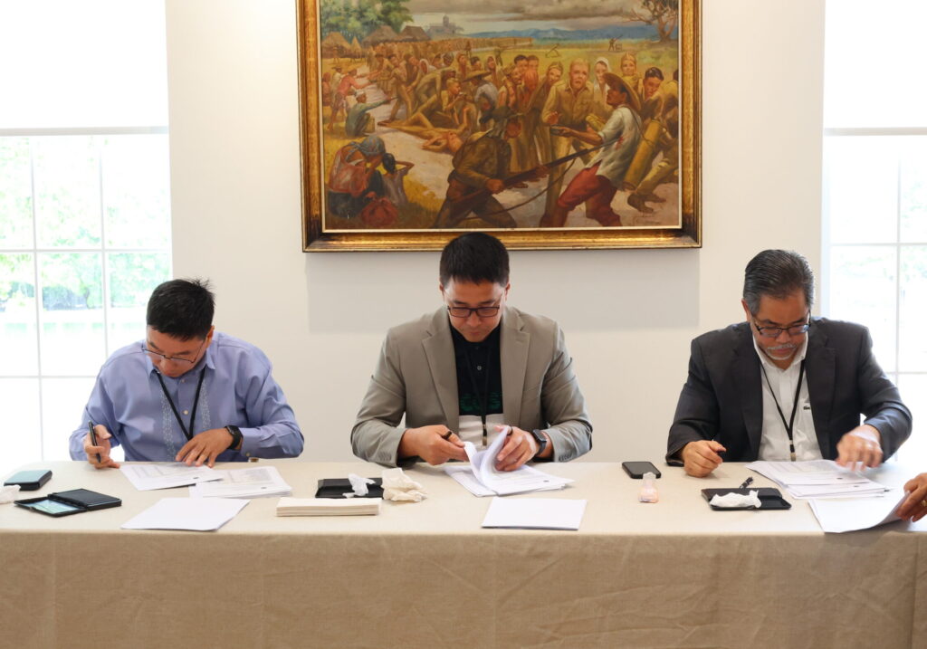 Members of the Special Board of Canvassers sign the Certificate of Canvas after consolidating the election results of all 30 clustered precincts in the United States.