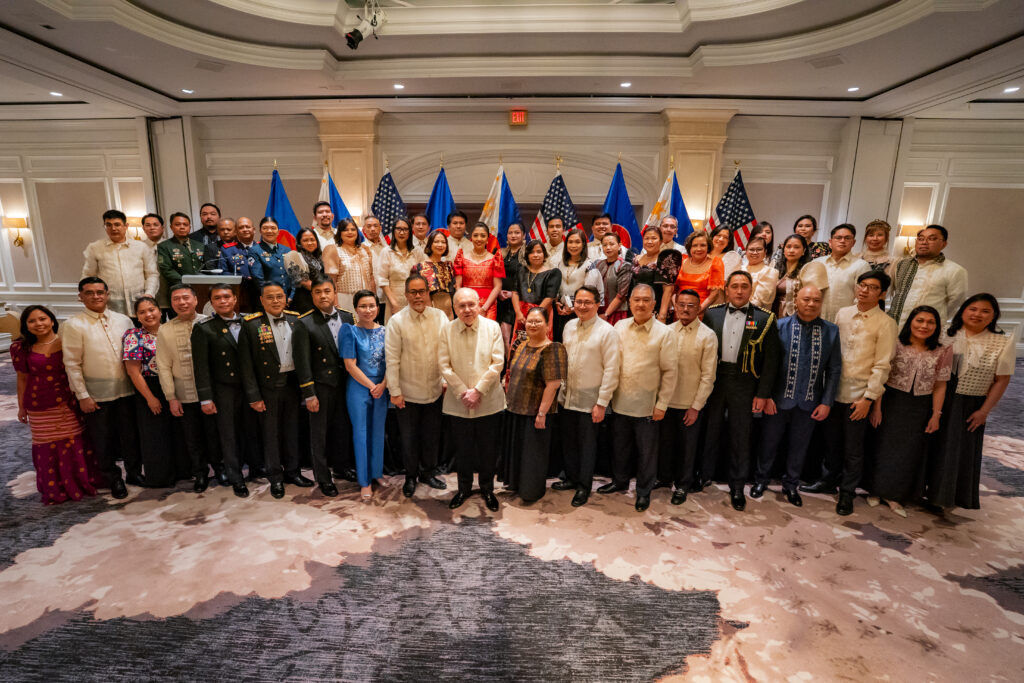 Ambassador Romualdez and Embassy personnel pose for a family photo.