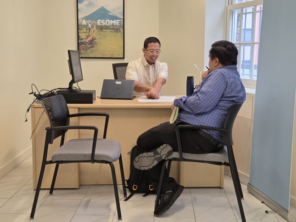 A client (right) consults with Atty. Dion Romano (left) on Philippine property law during a free legal aid clinic at the Philippine Embassy on 11 July 2025.
