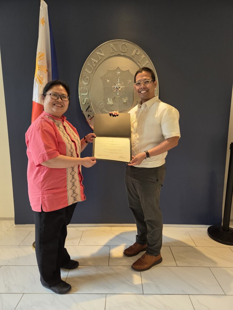Consul General Donna Rodriguez presents a certificate of appreciation to Atty. Dion Romano for providing pro bono legal advice on Philippine law.