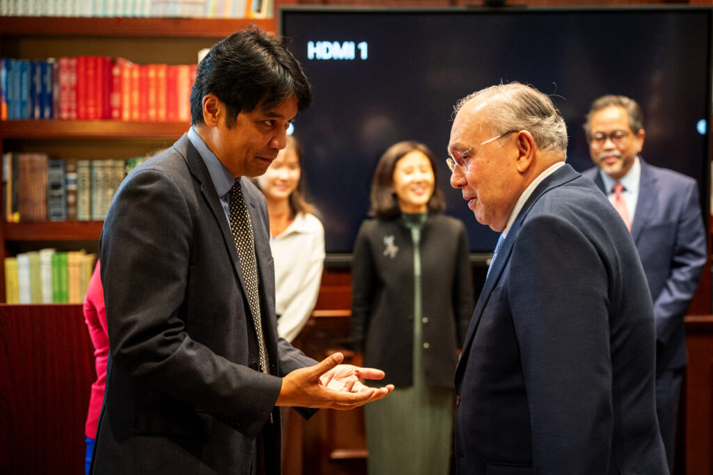 Professor Tiongson (left) welcomes Ambassador Romualdez (right), accompanied by Deputy Chief of Mission Jaime Ramon T. Ascalon, Jr. (background rightmost) to the Intercultural Center at Georgetown University for the signing of a donation agreement.