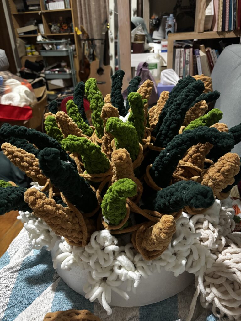 Behind the scenes of “The Grim Reefer”: wood pillars, netting, rugs, lots of yarn, and the help of friends and volunteers. (Photo credit: Erika Isleta)