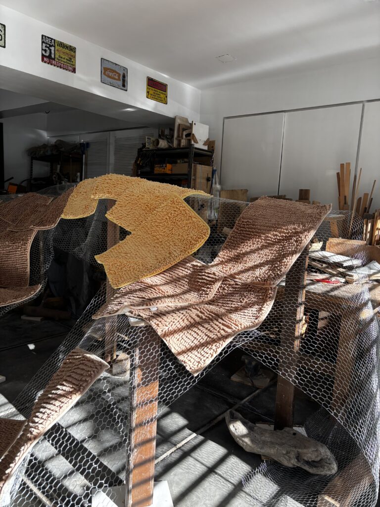 Behind the scenes of “The Grim Reefer”: wood pillars, netting, rugs, lots of yarn, and the help of friends and volunteers. (Photo credit: Erika Isleta)