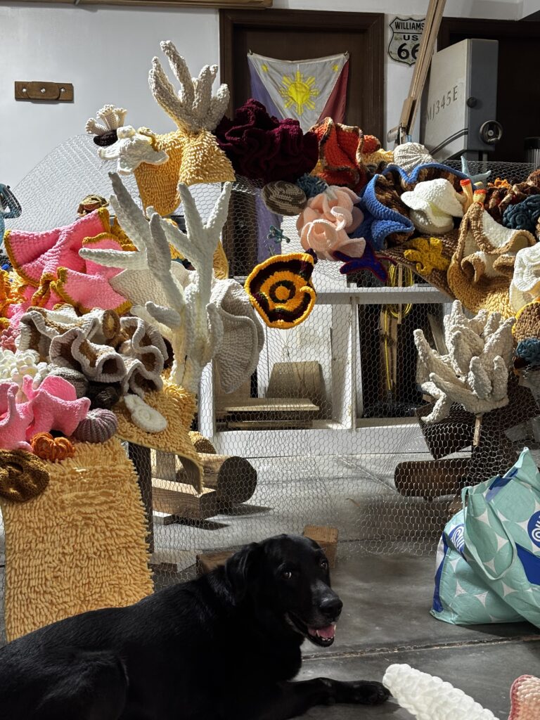 Behind the scenes of “The Grim Reefer”: wood pillars, netting, rugs, lots of yarn, and the help of friends and volunteers. (Photo credit: Erika Isleta)