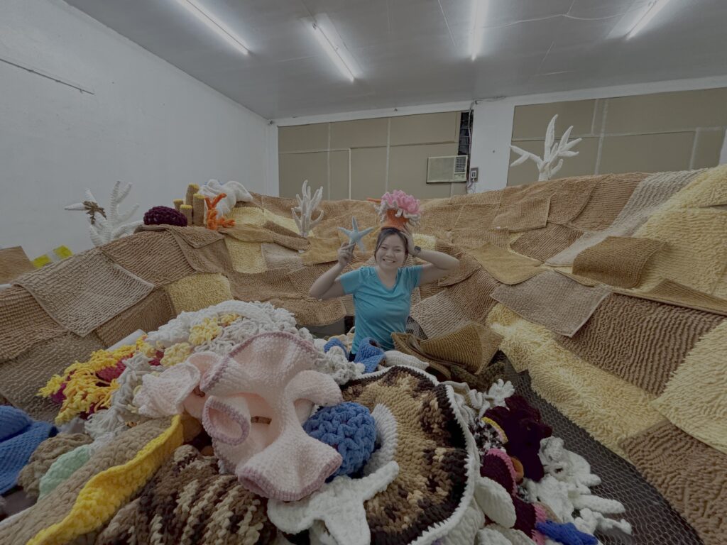 Behind the scenes of “The Grim Reefer”: wood pillars, netting, rugs, lots of yarn, and the help of friends and volunteers. (Photo credit: Erika Isleta)