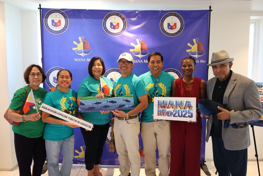 Members and friends of UNIFFIED Maryland pose at the MANAMo-themed photo booth.