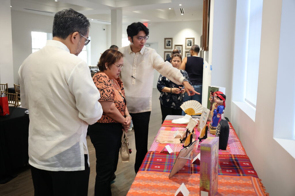 Participants browse the cultural displays featuring iconic elements of Filipino life and tradition.