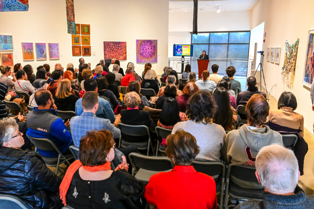 Dr. Tiffany Hunt welcomes museum guests to the Fabricated Boundaries Gallery Talk.