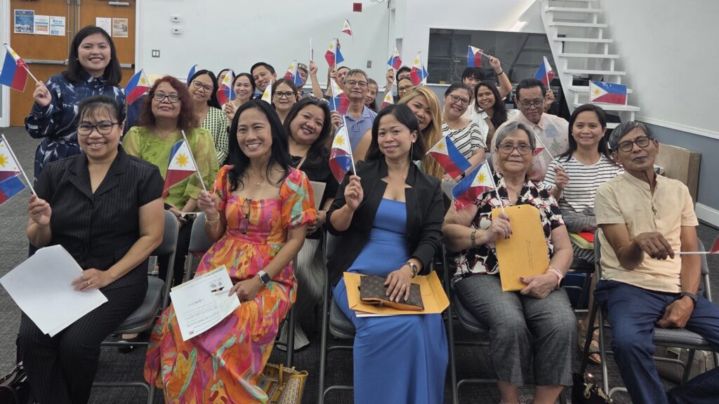 New dual citizens proudly wave Philippine flags after their oath taking ceremony at the Embassy’s consular outreach mission held on 17 October 2025 in Orlando, Florida.
