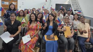 New dual citizens proudly wave Philippine flags after their oath taking ceremony at the Embassy’s consular outreach mission held on 17 October 2025 in Orlando, Florida.