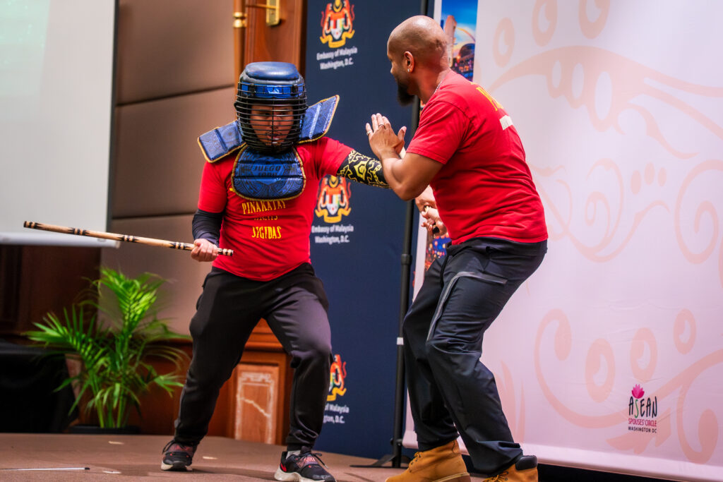 Pinakatay Arnis Sigidas students spar and attempt to disarm each other during the onstage demonstration at the 2025 ASEAN Culture Day.