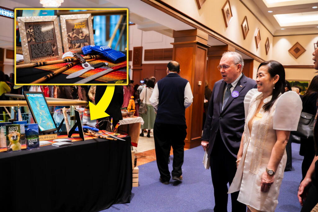Ambassador Jose Manuel Romualdez inspects the Philippine booth during the 2025 ASEAN Culture Day festivities. (Inset) Arnis training weapons were featured along with brochures, postcards, and other Filipino giveaways and display products.