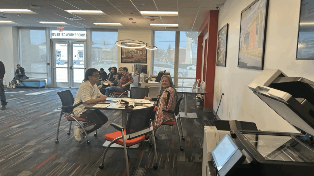 A Filipino community volunteer checks an applicant’s appointment schedule while others wait for their numbers to be called.
