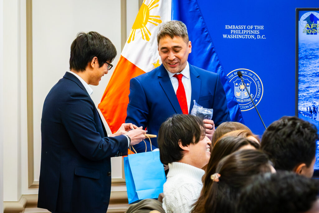 Representing the group, the Georgetown student leader extends a token of thanks to the Embassy for hosting their study visit.
