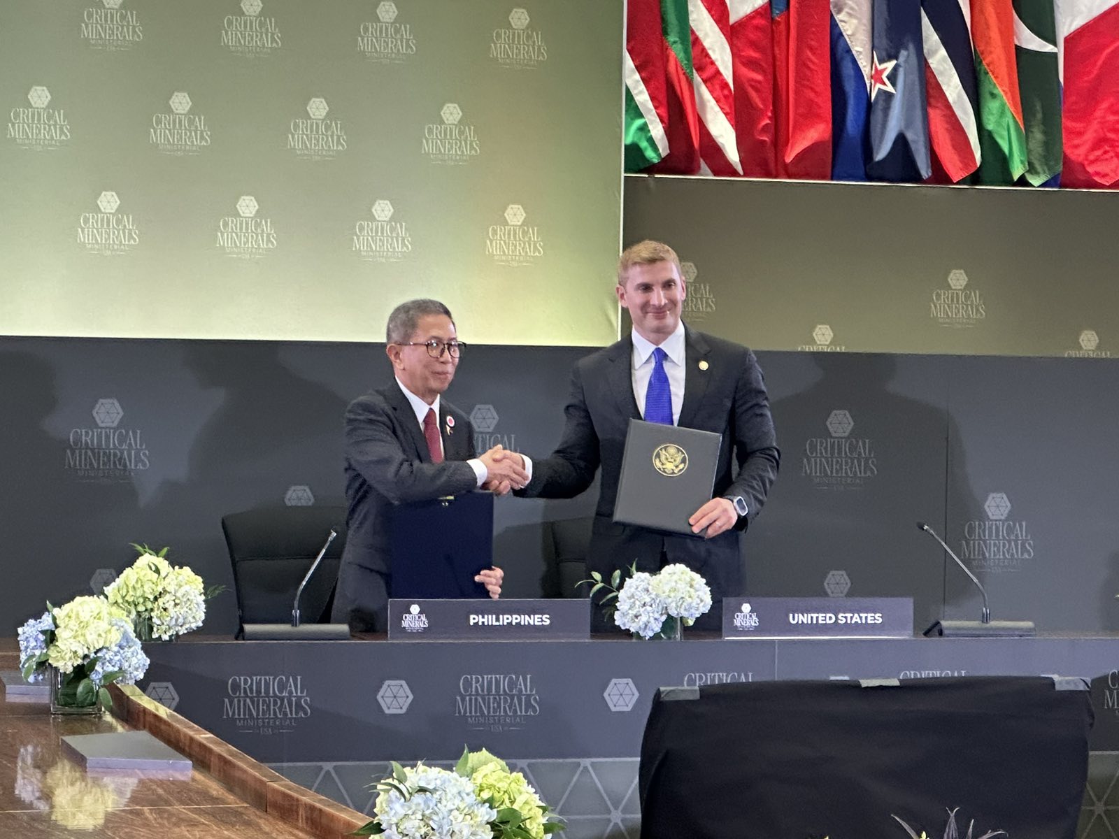 Hon. Raphael P.M Lotilla (left), Secretary of Environment and Natural Resources, and Hon. Jacob Helberg (right), Under Secretary of State for Economic Affairs, shake hands after the MOU signing.