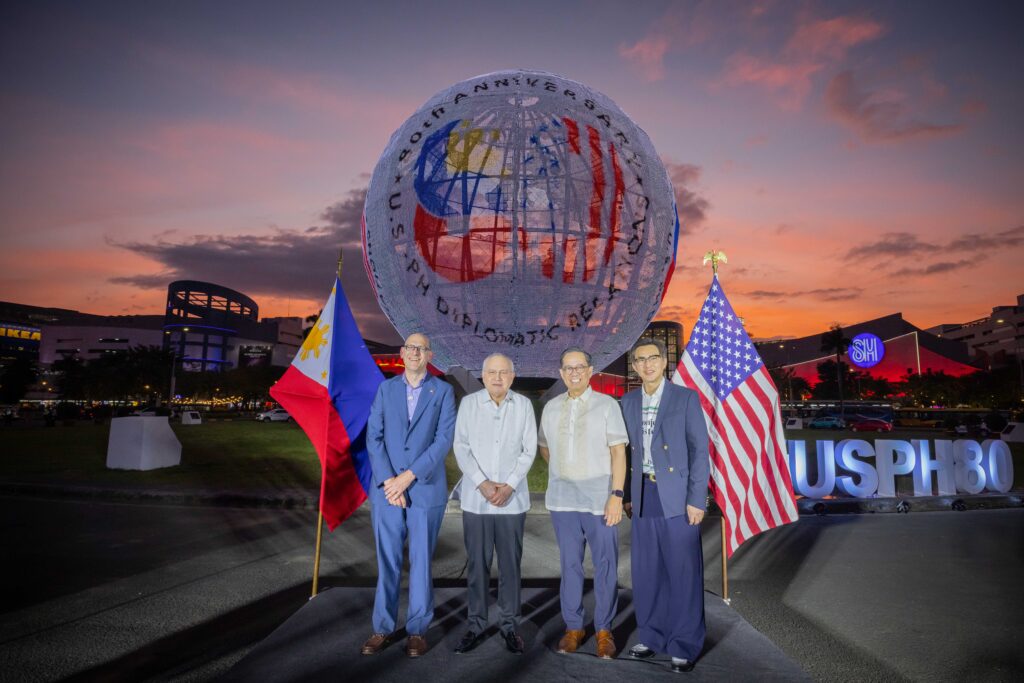 (Left to right) U.S. Embassy Chargé d’Affaires a.i. Y. Robert Ewing, Philippine Ambassador to the United States Jose Manuel Romualdez, DFA Undersecretary for Policy Leo Herrera-Lim, and SM Supermalls President Steven Tan pose at the SM Mall of Asia Globe as it lights up with the 80th anniversary logo of Philippines–United States diplomatic relations, marking the start of a yearlong commemoration. Photo Credit: US Embassy Manila