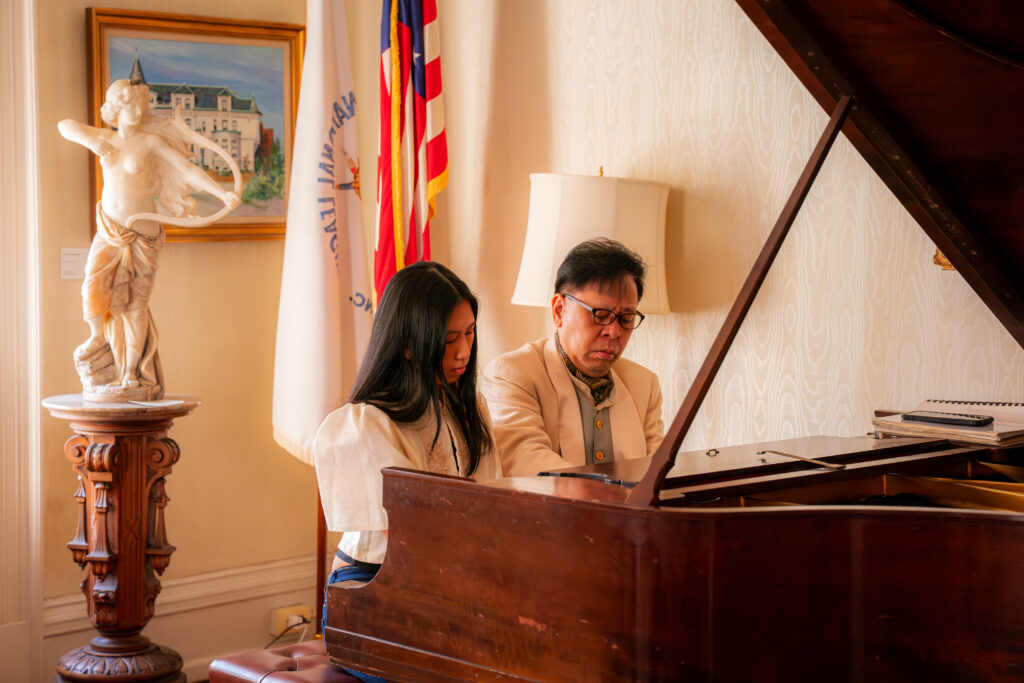 Following a brief chat with the DCM, the duo delighted DCM Cari&ntilde;o with a short piano piece offering a glimpse of what would be shared with the WIPAC audience.