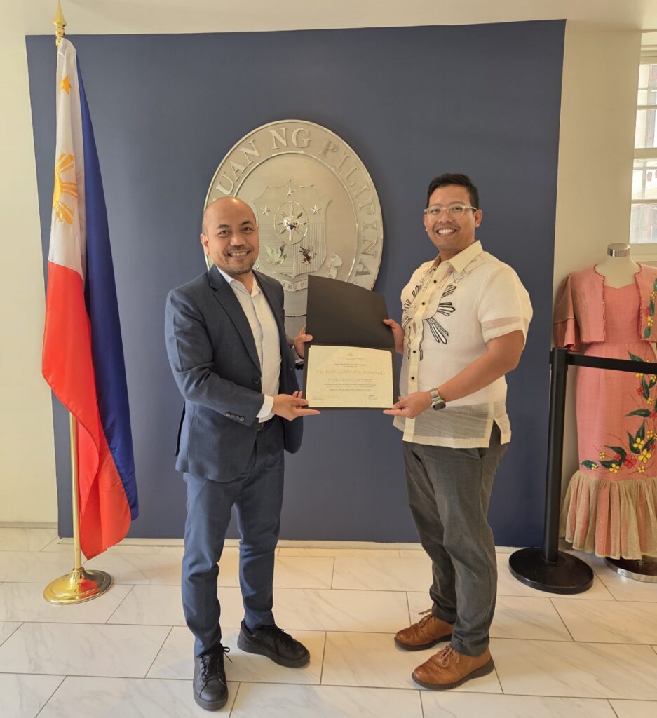Consul General Zoilo Velasco (left) presents a certificate of appreciation to Atty. Dion Romano (right) for providing pro bono legal advice on Philippine law.