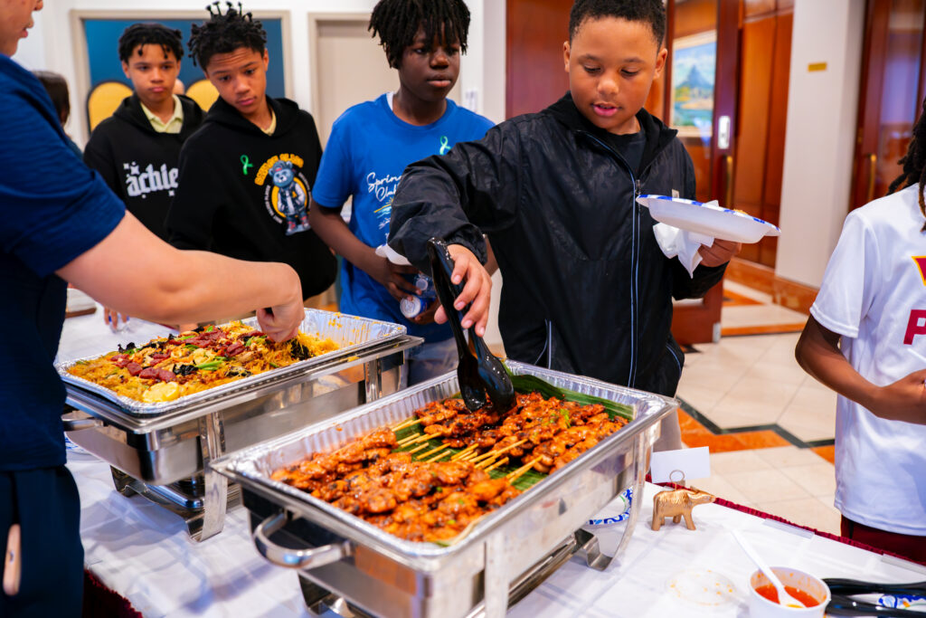 Students enjoy Filipino cuisine during the culmination of the Embassy Adoption Program.