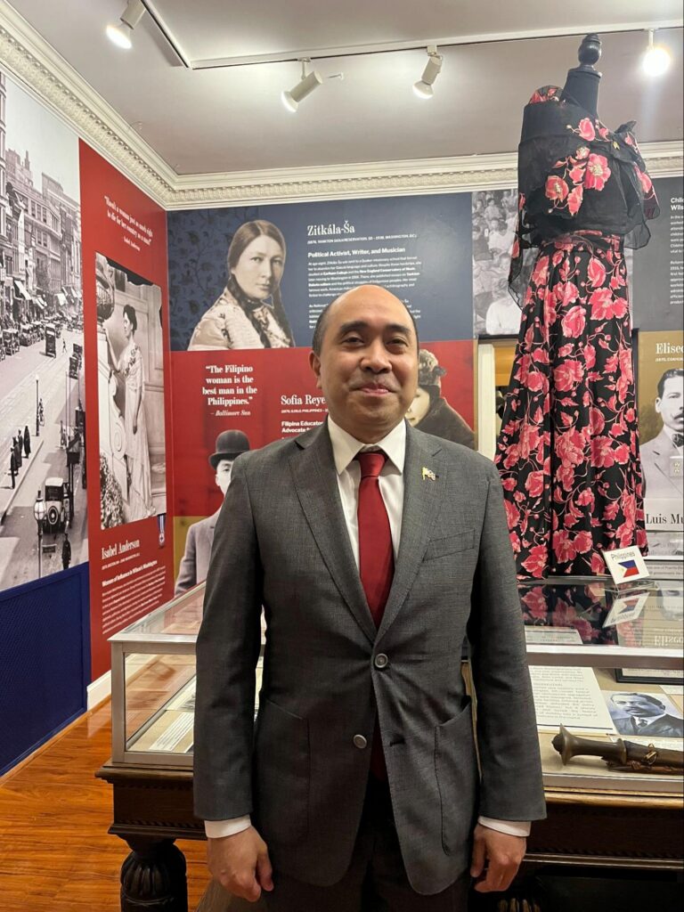DCM Cari&ntilde;o at the opening reception of the Fashioning Power, Fashioning Peace exhibition at the Woodrow Wilson House, with the Philippine Filipiniana piece displayed behind him.