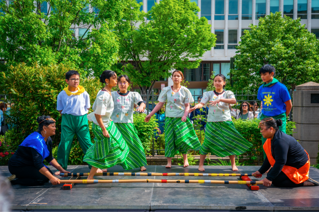 The Mabuhay, Inc. Dance Ensemble brought Filipino traditions to life with vibrant performances of Bulaklakan, a lively floral dance inspired by the Santa Cruz de Mayo festival, and Singkil, rooted in Maranao heritage, Singkil portrays a royal princess gracefully navigating an earthquake caused by forest spirits, as she moves between clashing bamboo poles with the aid of fans symbolizing wind and nature. The celebration continued beyond the stage, as guests joined in and tried Tinikling themselves, stepping into the rhythm and energy of one of the Philippines&rsquo; most beloved dances.