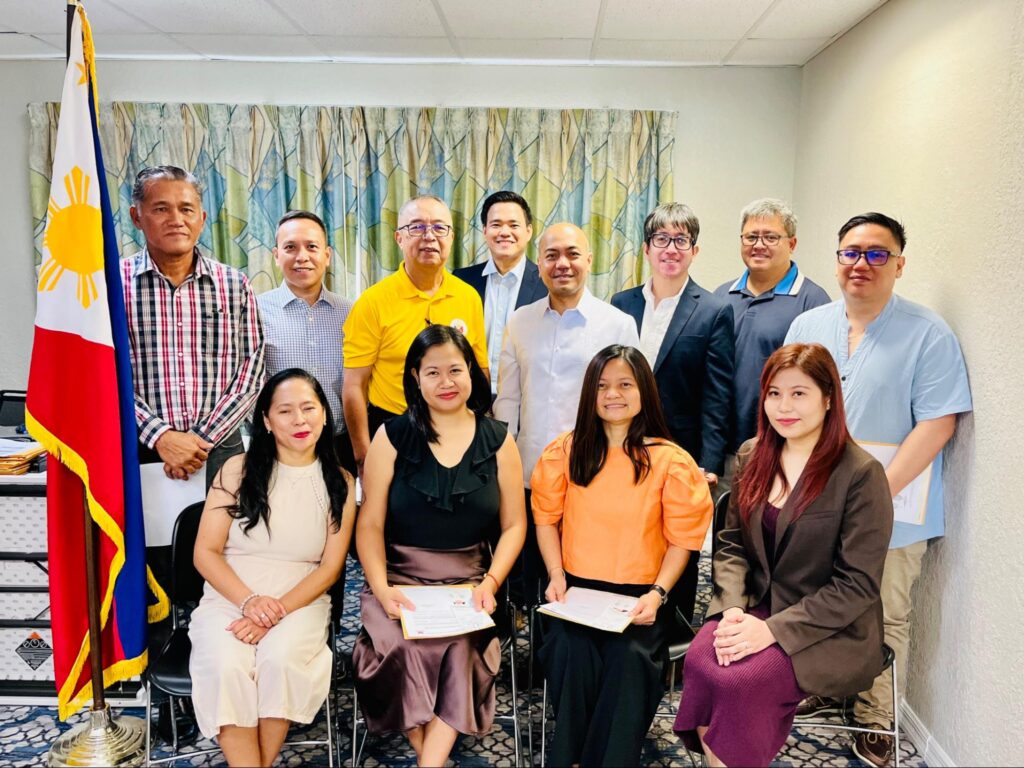 Consul General Velasco (middle) with applicants who reacquired their Filipino citizenship.