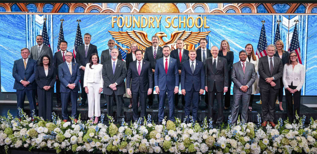 U.S. Vice President J.D. Vance (1st row, 6th from right), Secretary of State Marco Rubio (1st row, 6th from left), and Undersecretary of State Jacob Helberg (1st row, 5th from right) are joined by key university and business leaders during the launch of the Foundry School. (photo courtesy of the U.S. Department of State)