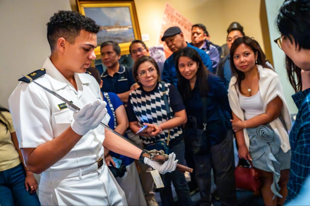 MIDN 2/C Ian Mullaney displays a headhunters sword from the Philippines that forms part of the USNA archival collection.
