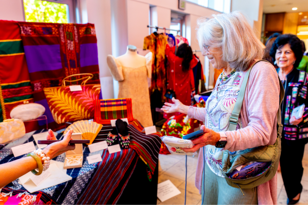 Guests stop by the Philippine booth to examine the displays and ask our curators about the stories and traditions represented in the exhibit.